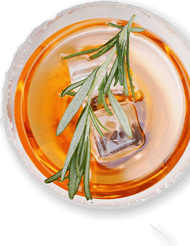 Orange-colored cocktail with a rosemary sprig