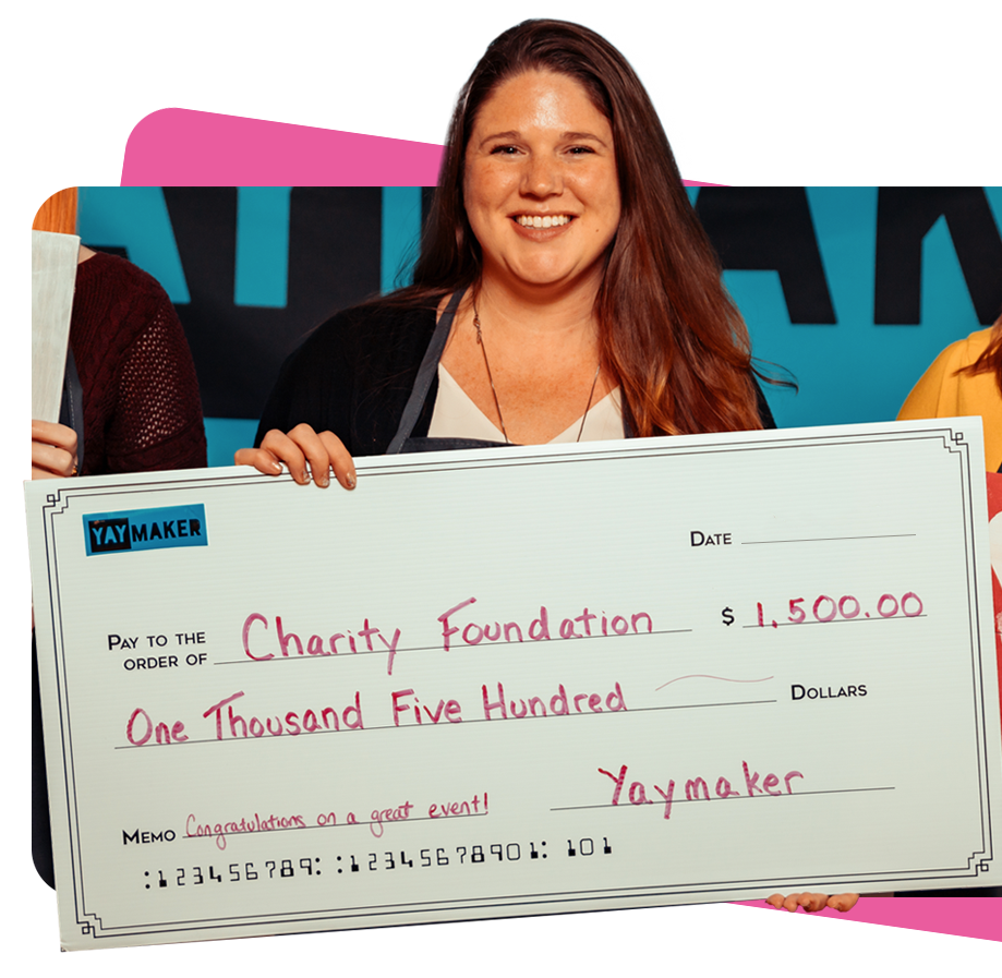 Lady holding giant check from charity event