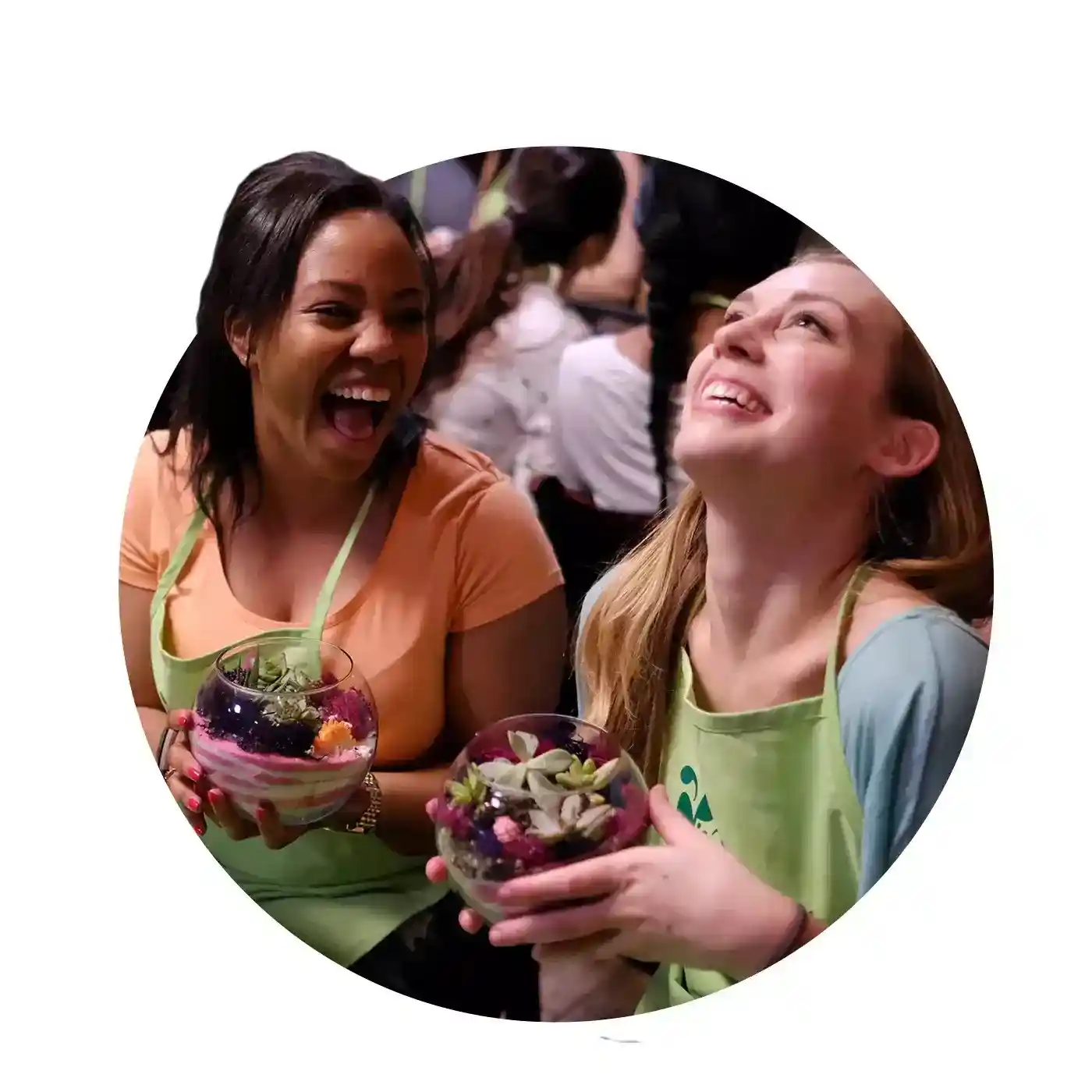 Two female friends laughing with finished Plant Nite projects.

                          