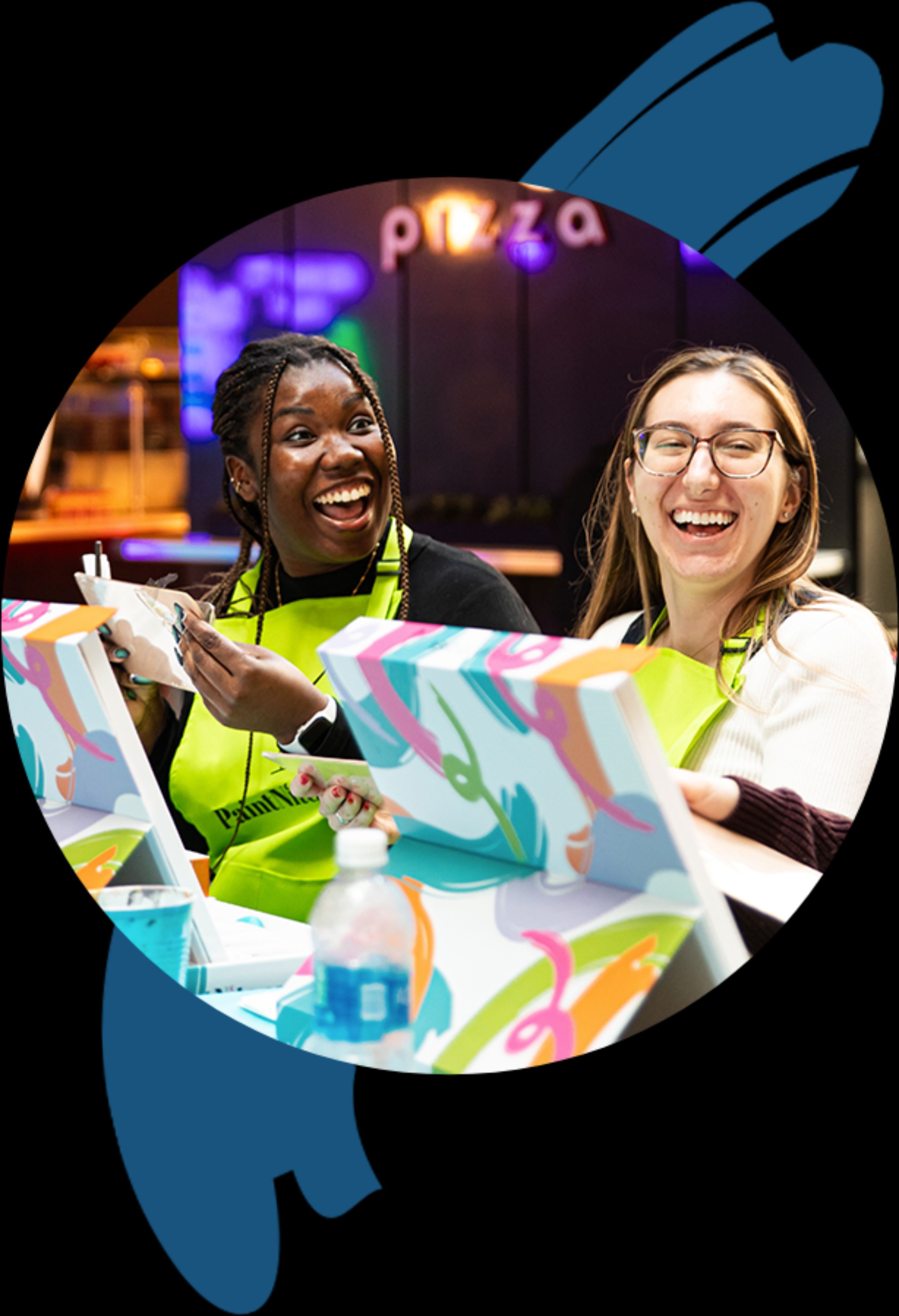 Two girls laughing and smiling at a PaintNite.com event.