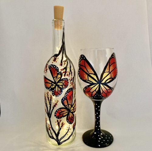 A Social Butterfly Wine Bottle with Fairy Lights and Wine Glass paint nite project by Yaymaker